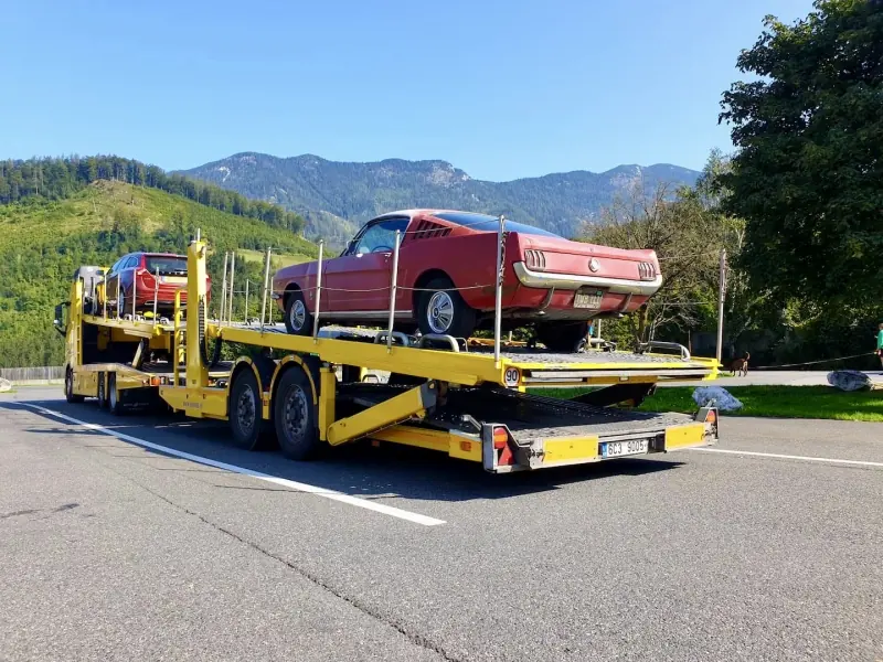 Classic red car on the transporter deck
