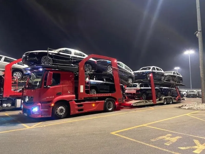 Car transporter fully loaded at night